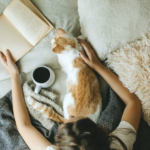 5 lessons you can learn from a cat. cat with woman reading a book